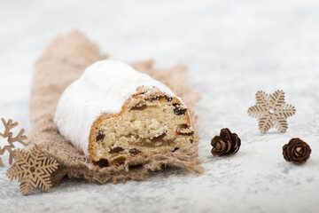 Christstollen, traditonal christmas cake with nuts, raisons, marzipan on a blue background, empty space for text