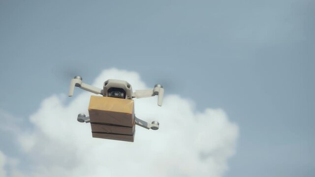 flying on a sky delivery drone with holding a .cardboard parcel