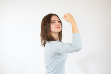Young woman over isolated white background doing strong gesture