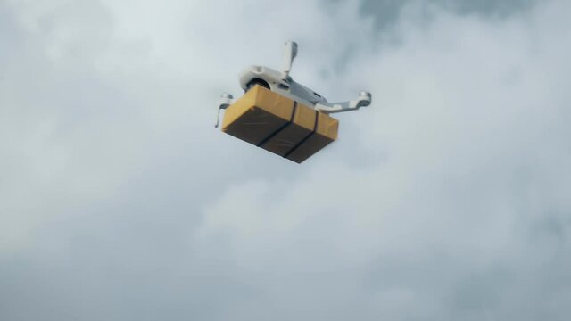 flying on a sky delivery drone with holding a .cardboard parcel