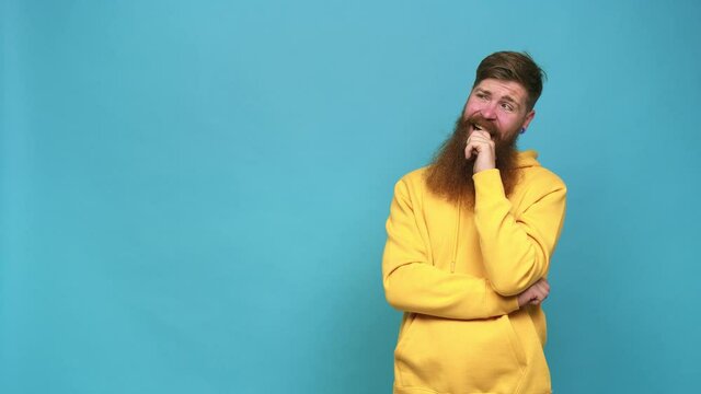 Young adult bearded caucasian man isolated relaxed thinking about something looking at a copy space