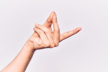 Close up of hand of young caucasian man over isolated background snapping fingers for success, easy and click symbol gesture with hand