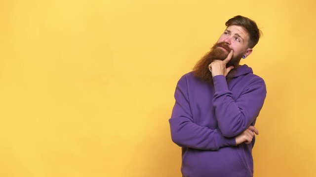 Young adult bearded caucasian man isolated looking sideways with doubtful and skeptical expression