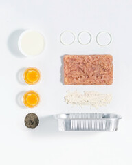 Knolling food with eggs, meet, milk, onion rings and pepper for stuffed pancakes