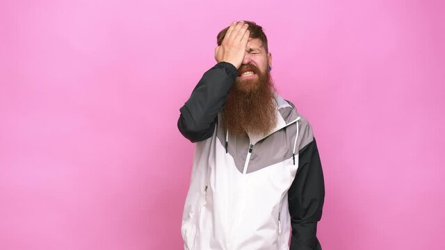 Young adult bearded caucasian man isolated forgetting something, slapping forehead with palm and closing eyes