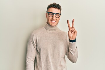 Fototapeta premium Handsome young man wearing casual winter sweater mouth and lips shut as zip with fingers. secret and silent, taboo talking