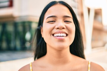 Young asian girl smiling happy at the city