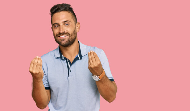 Handsome man with beard wearing casual clothes doing money gesture with hands, asking for salary payment, millionaire business