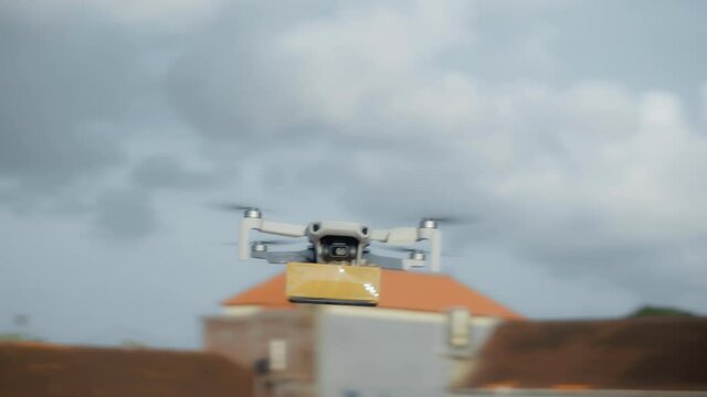 flying on a sky delivery drone with holding a .cardboard parcel