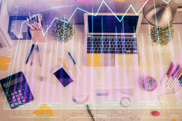 Double exposure of forex chart drawing over table background with computer. Concept of financial research and analysis. Top view.
