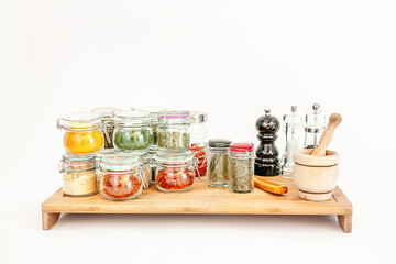 jars of spices on bamboo board
