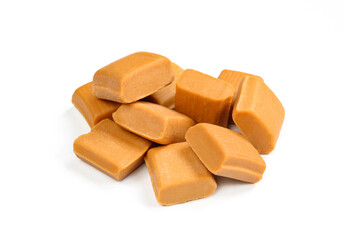 Pile of caramel candies isolated
on white background. Group of unhealthy toffee squares