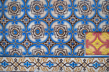 Traditional old tiles wall on the street Portuguese painted tin-glazed, azulejos ceramic tilework. Portugal.