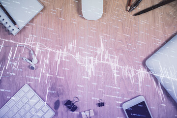 Multi exposure of forex graph hologram over desktop with phone. Top view. Mobile trade platform...