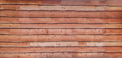 Wall of waney uneven edge wooden boards 