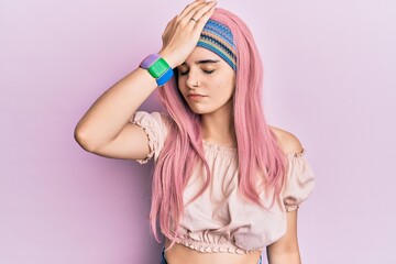 Young hispanic girl with pink hair surprised with hand on head for mistake, remember error. forgot, bad memory concept.