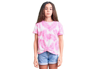 Obraz premium Cute hispanic child girl wearing casual clothes relaxed with serious expression on face. simple and natural looking at the camera.