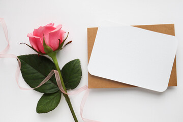 mock up greeting card. bouquet of pink roses and an envelope. place for text. congratulation. invitation