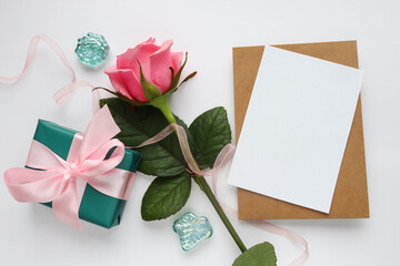 mock up greeting card. bouquet of pink roses and an envelope. place for text. congratulation. invitation