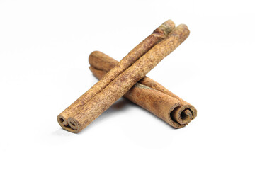 Brown cinnamon sticks isolated on white background. Aromatic food ingredients