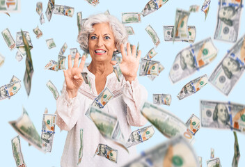 Senior grey-haired woman wearing casual clothes showing and pointing up with fingers number nine...