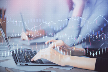 Multi exposure of woman hands typing on computer and financial chart hologram drawing. Stock market analysis concept.