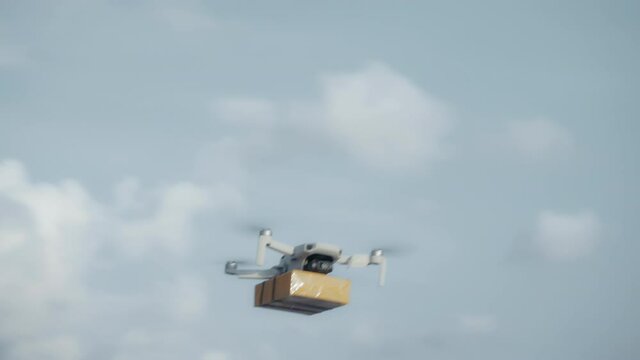 flying on a sky delivery drone with holding a .cardboard parcel