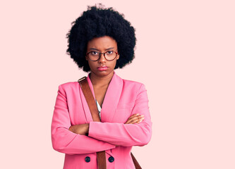 Young african american woman wearing business clothes and leather bag skeptic and nervous, disapproving expression on face with crossed arms. negative person.