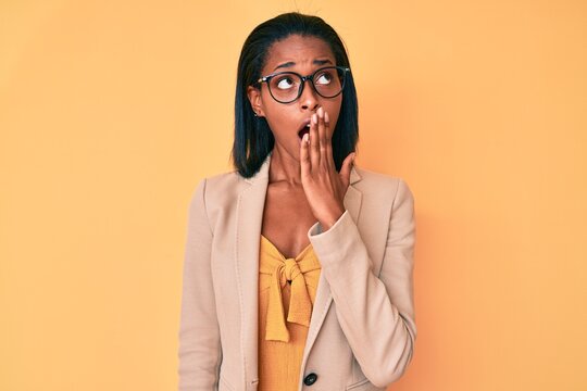 Young african american woman wearing business clothes bored yawning tired covering mouth with hand. restless and sleepiness.