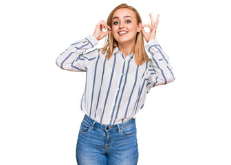 Beautiful caucasian woman wearing casual clothes smiling pulling ears with fingers, funny gesture. audition problem