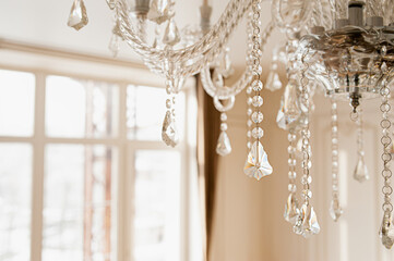 crystal stylish vintage hanging chandelier with crystals and beaded close-up. sparkling bokeh, selective focus