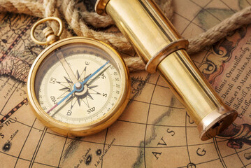 compass and rope on old map