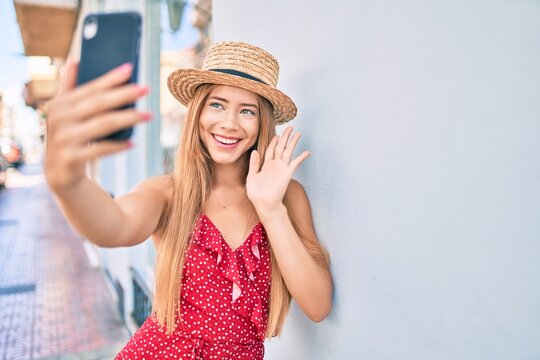 Young caucasian tourist girl smiling happy doing video call using smartphone at the city.