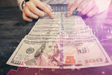 Multi exposure of forex graph drawing hologram and USA dollars bills and man hands. Technical Analysis concept.