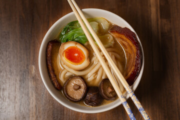 Japanese ramen soup with pork (chasu), marinated egg, pak choi, shiitake, smoked tofu and noodles