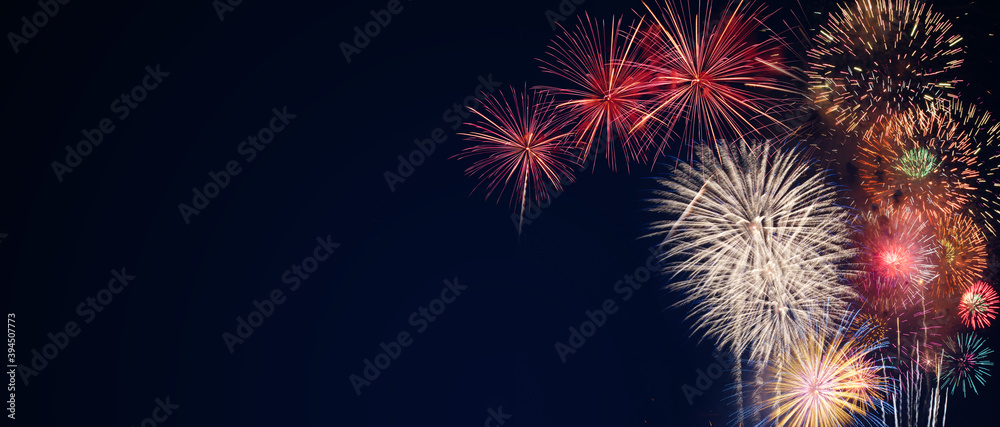 Poster colorful fireworks on the black sky background with free space for text. Celebration and anniversary concept