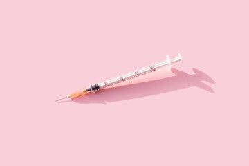 Syringe of pink background. Colorful concept of New Corona virus 2019-nCoV or COVID-19 vaccine....