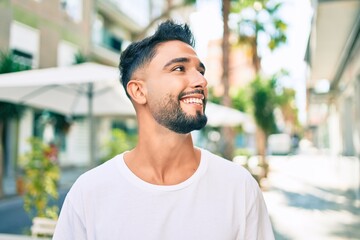 Fototapeta premium Young arab man smiling happy walking at the city.