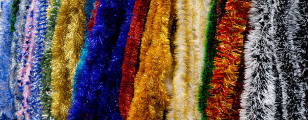 Bright striped New Year's Christmas background from multi-colored tinsel.