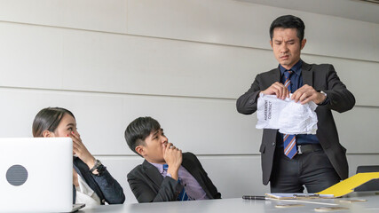aggressive boss businessman complain staff and tear document file in meeting conference room.