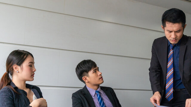 Aggressive Boss Businessman Holding Paper File Work And Complain Staff And Colleague In Meeting Conference Room