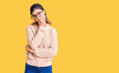 Young beautiful woman wearing casual winter sweater and glasses thinking looking tired and bored with depression problems with crossed arms.