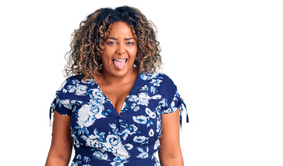 Young african american plus size woman wearing casual clothes sticking tongue out happy with funny expression. emotion concept.