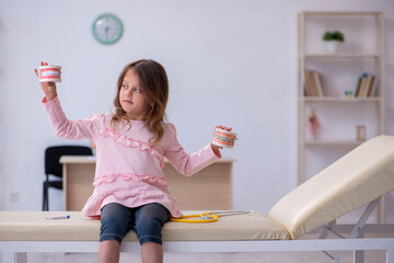 Small girl waiting for doctor stomatologist in the clinic