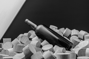 botella de vino sobre trozos de madera en blanco y negro 