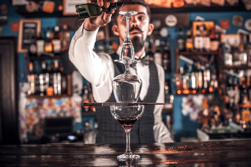Barman mixes a cocktail in the beerhouse