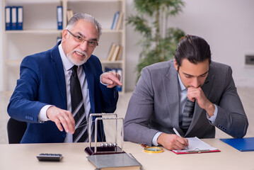 Two businessmen and meditation balls on the table