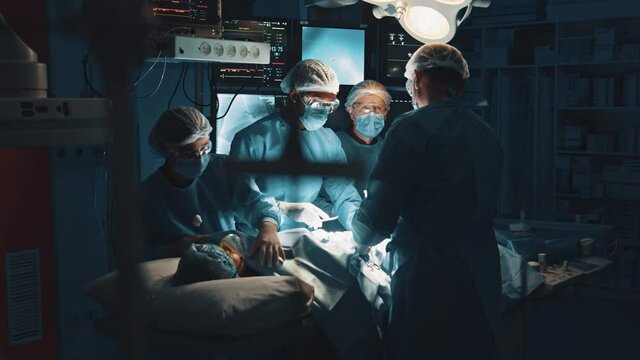 In dark operating room surgeons collaborating to perform successful heart transplant surgical operation. Patient undergoing surgery.