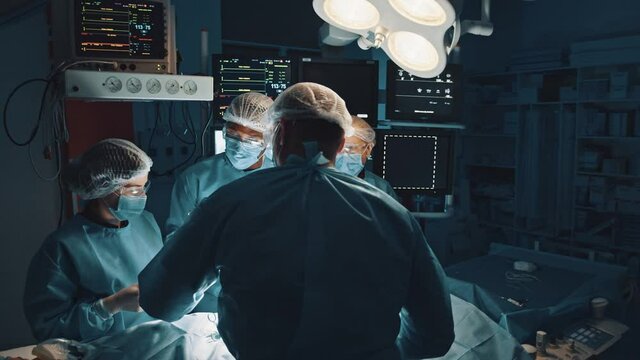 Heart surgery. Hospitals. Multi-race group of surgeon and several interns performing surgical operation. Professional surgery in private clinic. Medical concept.