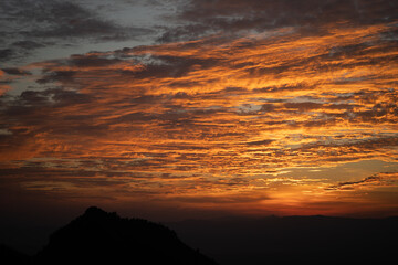 The sky is bright and beautiful with clouds at sunset.